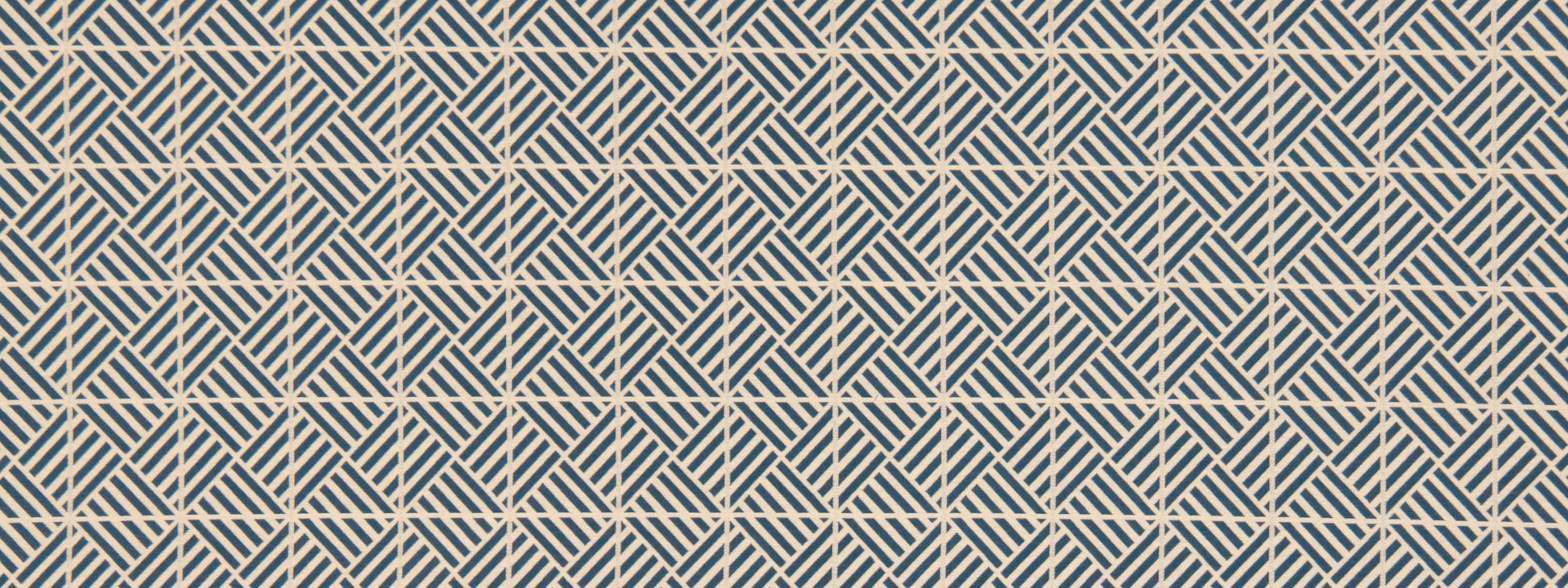 Cobalt blue upholstery fabric with a triangulation geometric pattern and cream accents.