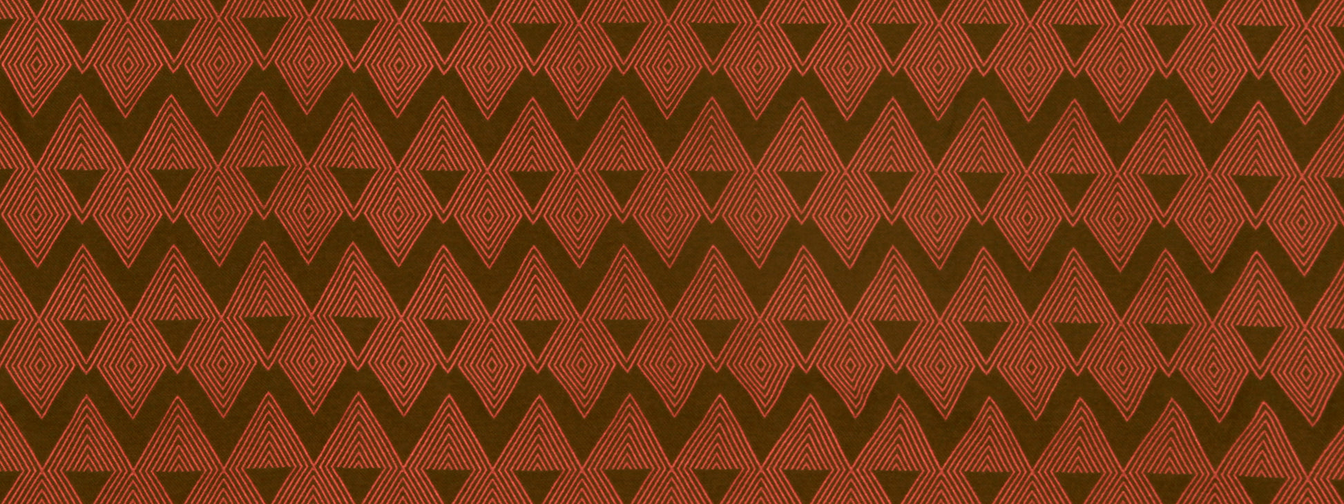 Repeating red-orange and brown geometric chevron/diamond pattern with fine line details on fabric texture