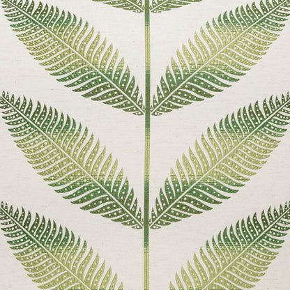 Cream pillow with a green floral motif featuring fern-like leaves and a symmetric repeating pattern.