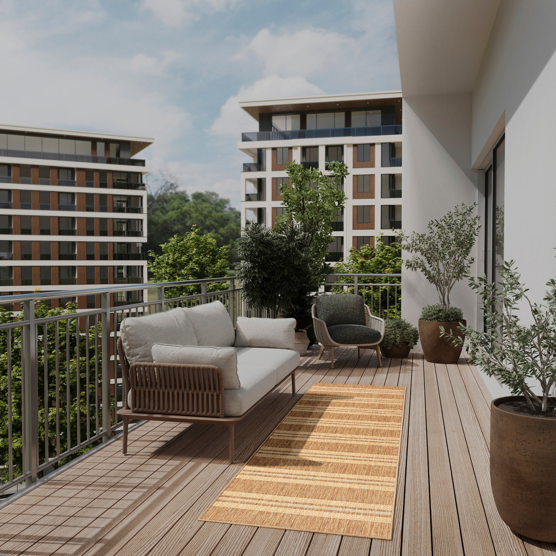 Modern balcony lounge with beige cushioned rattan sofa, wooden deck, striped jute rug, and potted plants.