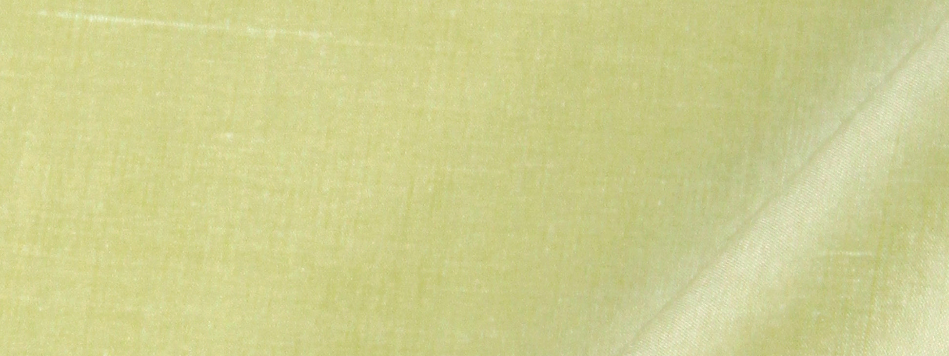 Close-up of lime-green silk fabric with visible weave texture.