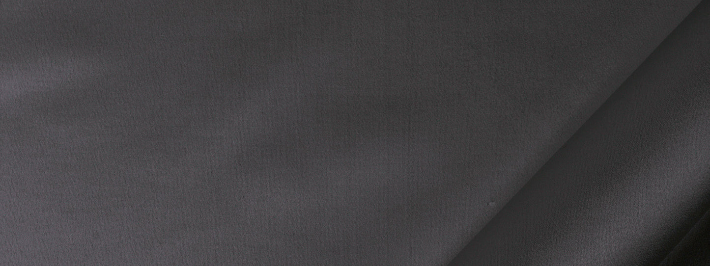 Dark gray fabric close-up with a diagonal seam, smooth matte texture suitable for drapery