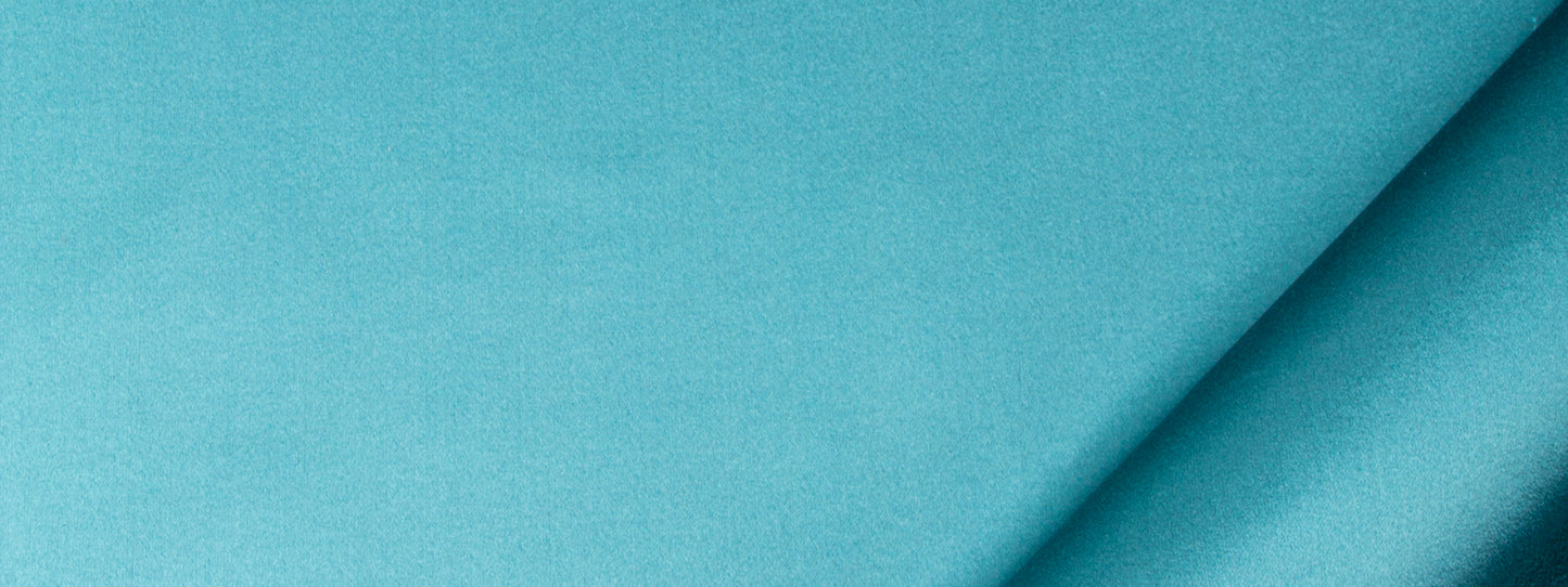 Teal satin fabric with a diagonal fold and silky texture.