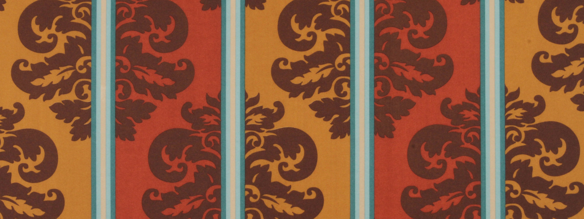 Vibrant damask print fabric with amber and rust panels, brown scroll motifs, separated by turquoise stripes.