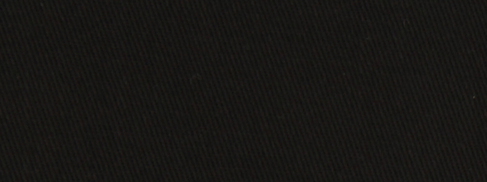 Close-up of black textured fabric with diagonal weave; matte finish, versatile for upholstery.