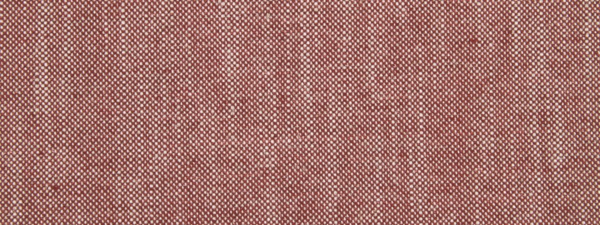 Close-up of crimson linen canvas upholstery fabric with a coarse weave and visible threads.