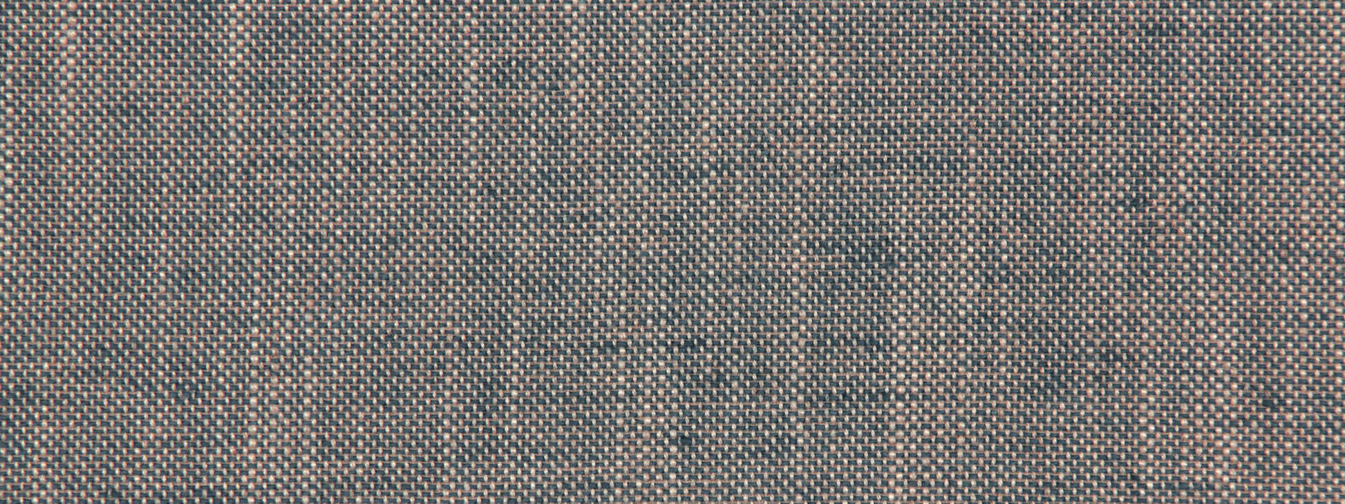 Blue cobalt linen canvas upholstery fabric close-up with a woven texture and tiny tan specks.