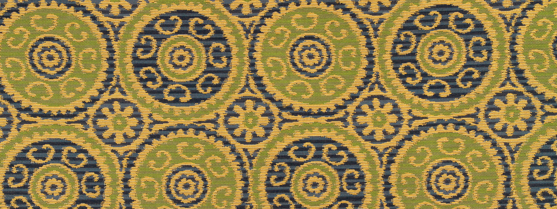 Mustard-yellow fabric with repeating green and navy circular medallions outlined in gold; ornate upholstery textile.