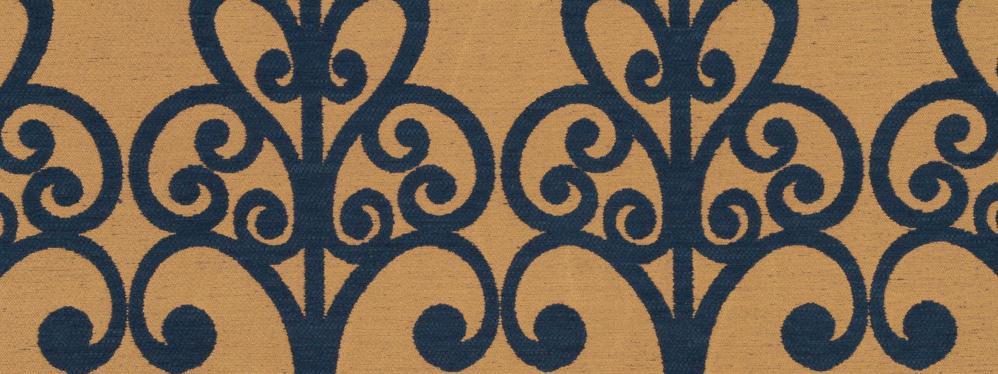 Intricate dark blue scrollwork arabesque pattern on warm tan background; classic upholstery fabric design.