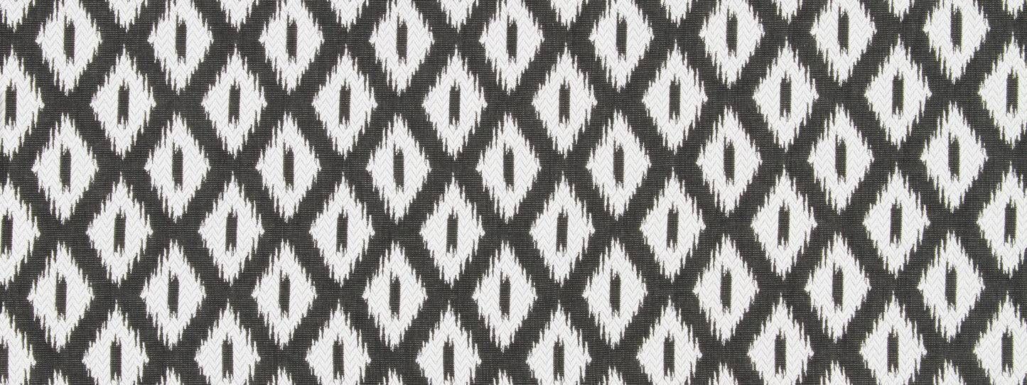 Woven black and white ikat diamond patterned fabric, repeating geometric motif.