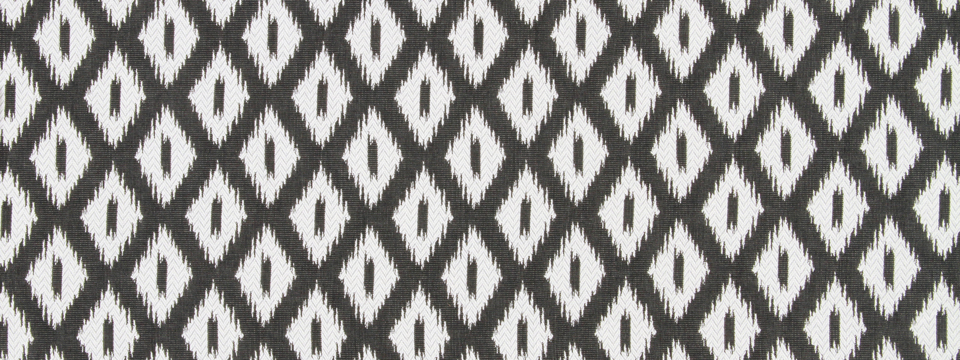 Woven black and white ikat diamond patterned fabric, repeating geometric motif.