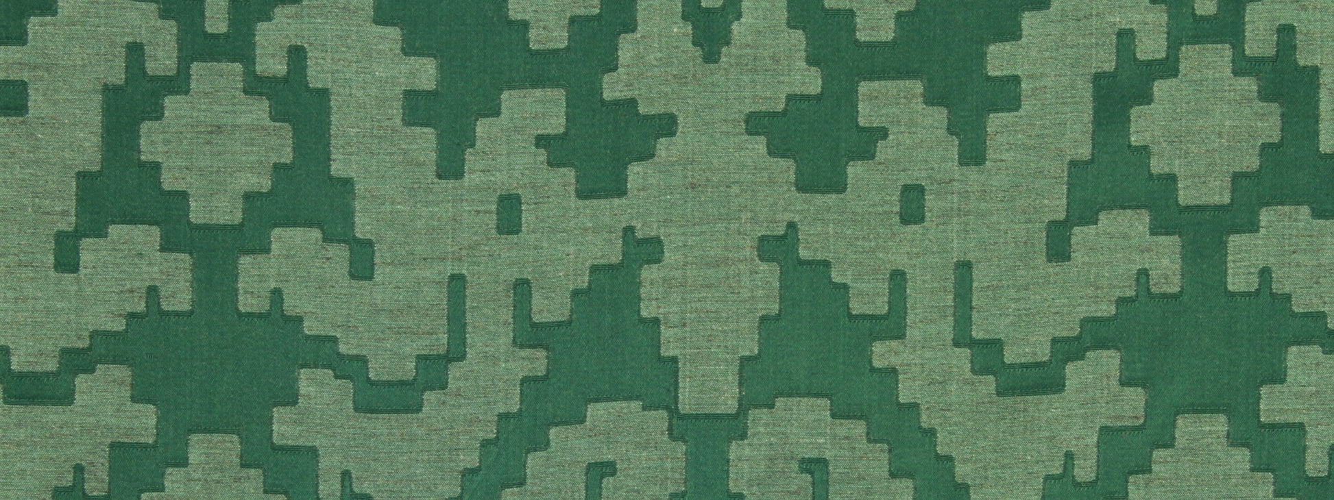 Green woven fabric with a bold dark-and-light green geometric block motif.