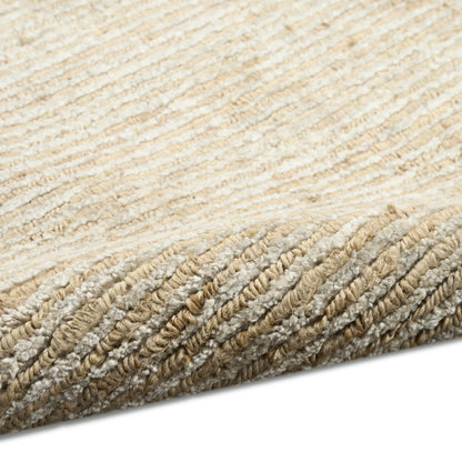 Neutral beige and cream rug with thick braided loops; textured, cozy coastal style for living room.