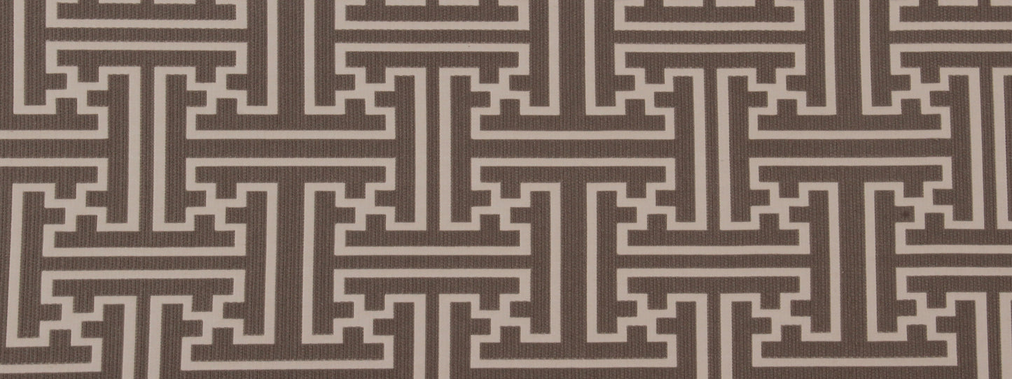 Brown textured fabric with cream Greek-key maze pattern in repeating panels.