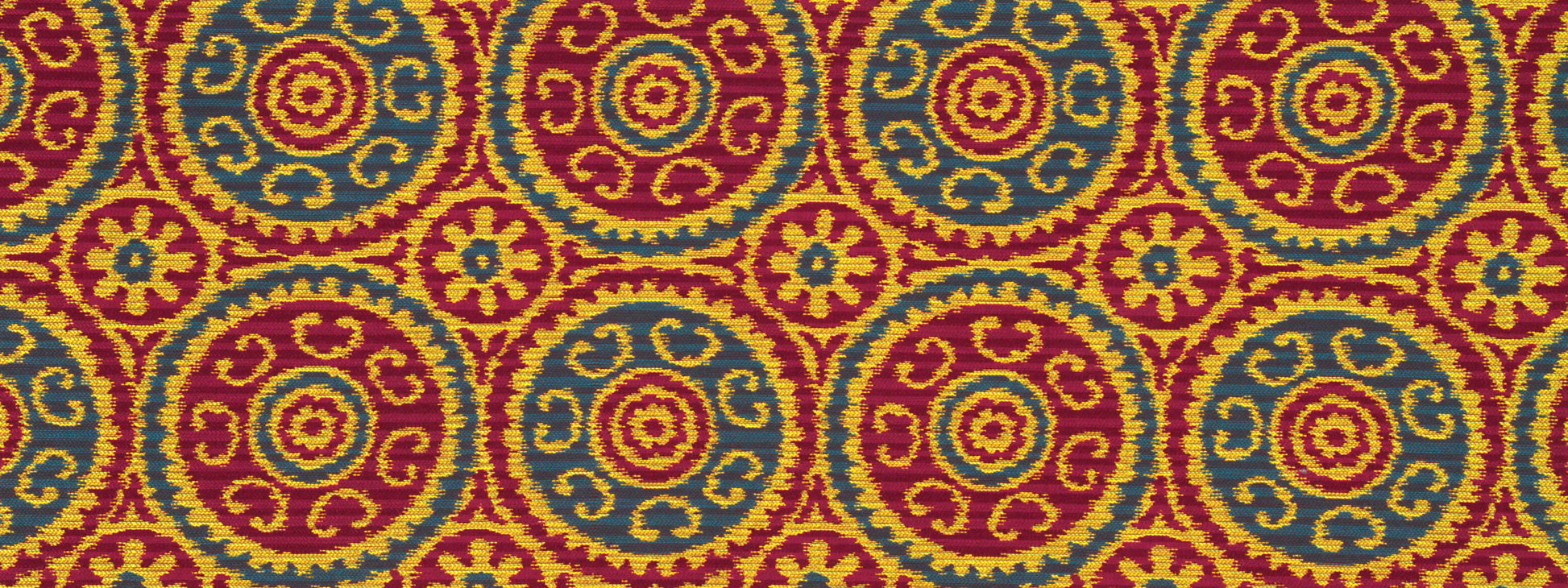 Repeating circular medallion motif in red, yellow & teal with floral swirls; ornate textile/woven pattern for upholstery.
