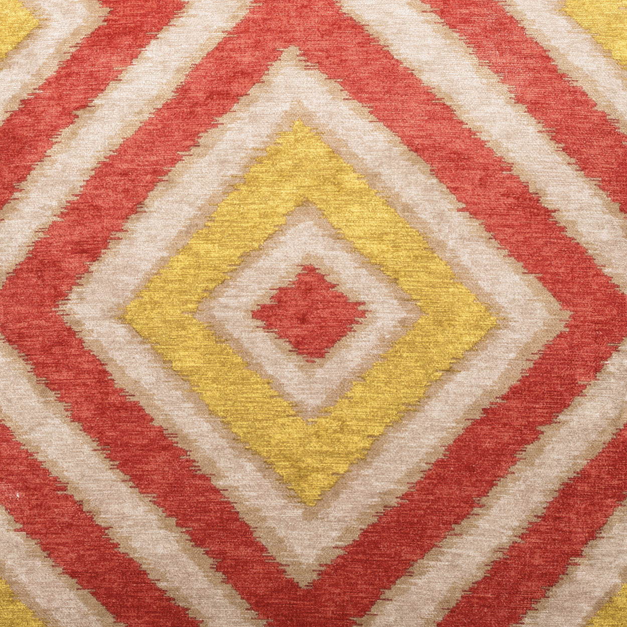 Textured geometric rug with concentric diamonds in red, yellow, cream & beige.