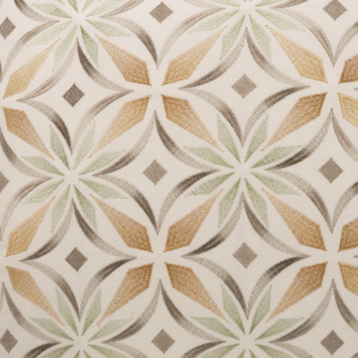 Textured fabric with a geometric rosette pattern of interlocking circles in beige, tan, pale green and gray on ivory.