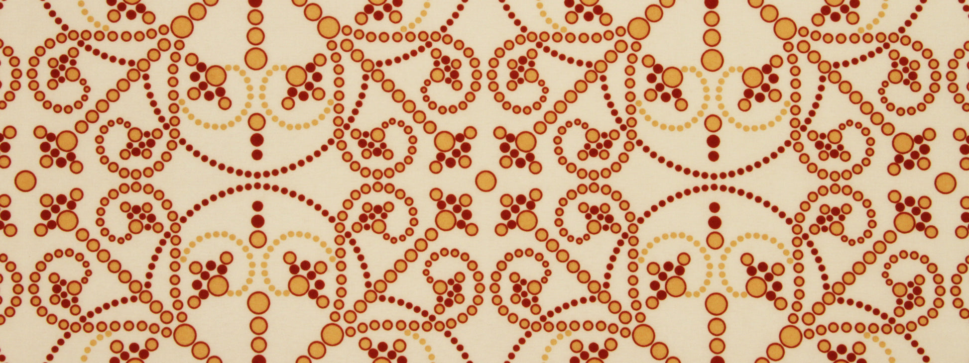 Beige textile with red-orange dotted circles in swirling, looping abstract motif.