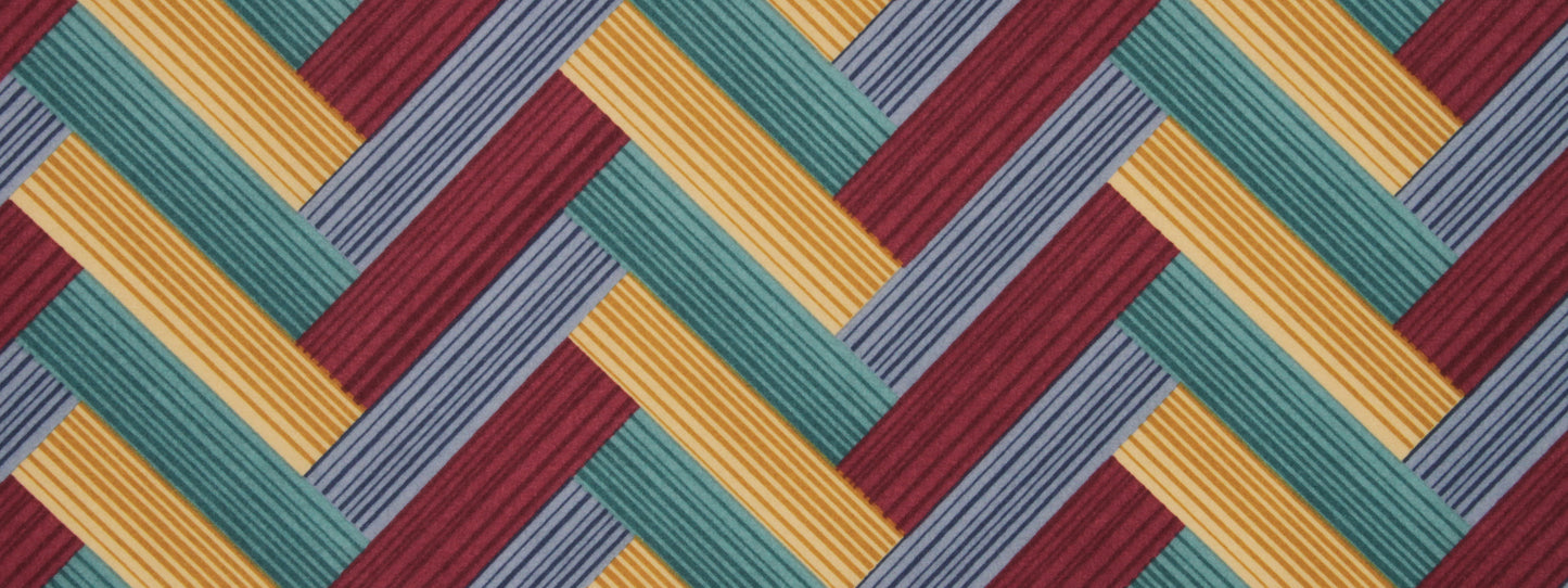 Chevron print fabric-like geometric diagonal stripe pattern in mustard yellow, teal, burgundy & lavender; woven interlocking blocks.
