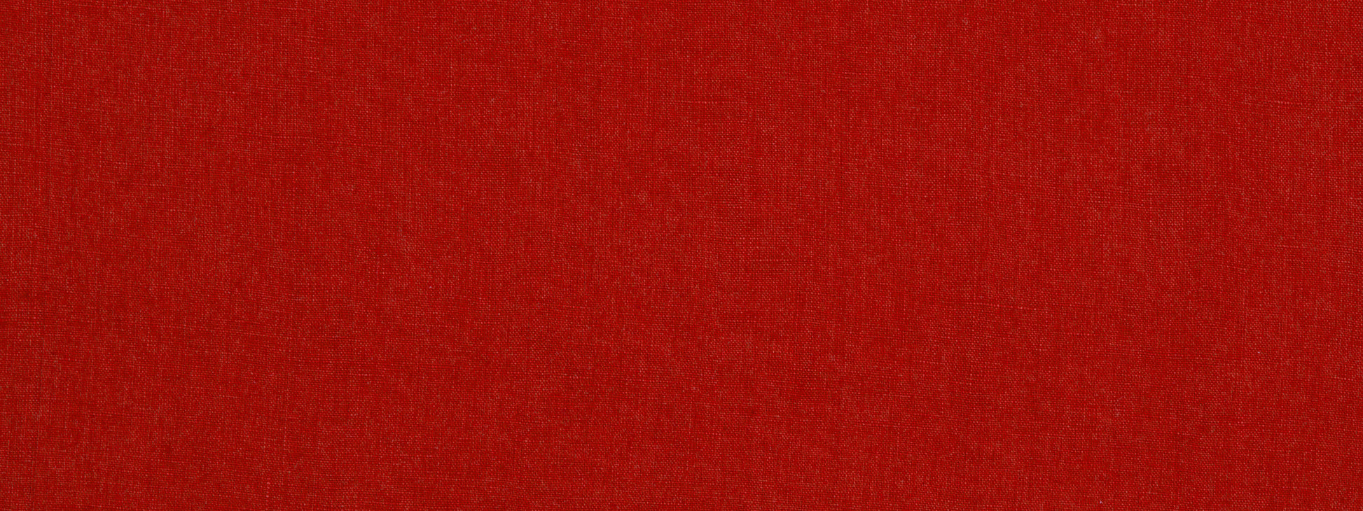 Solid red fabric texture close-up with subtle shading
