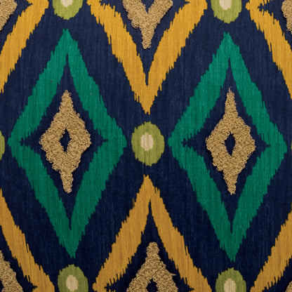 Navy woven fabric with green diamond motifs, mustard chevrons, and tan diamonds; bold geometric ikat-inspired textile.
