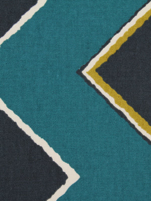 Teal and charcoal textile with white-outlined diamonds and mustard-yellow accents in a geometric pattern.