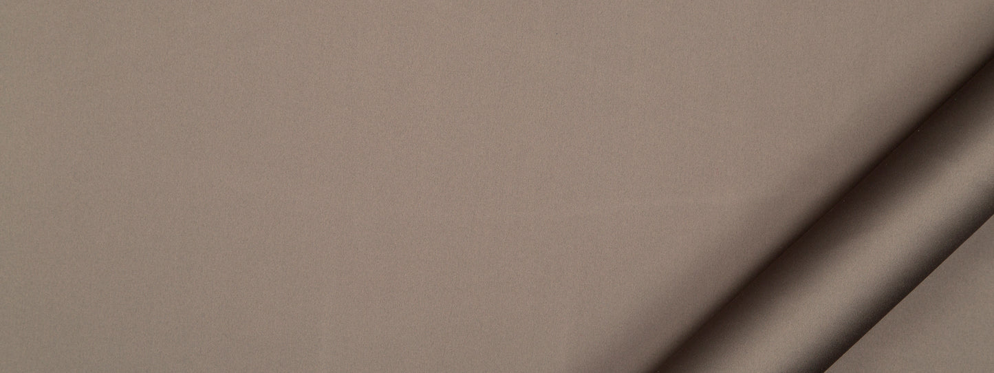 Taupe suede-like fabric close-up with rolled edge at bottom-right.