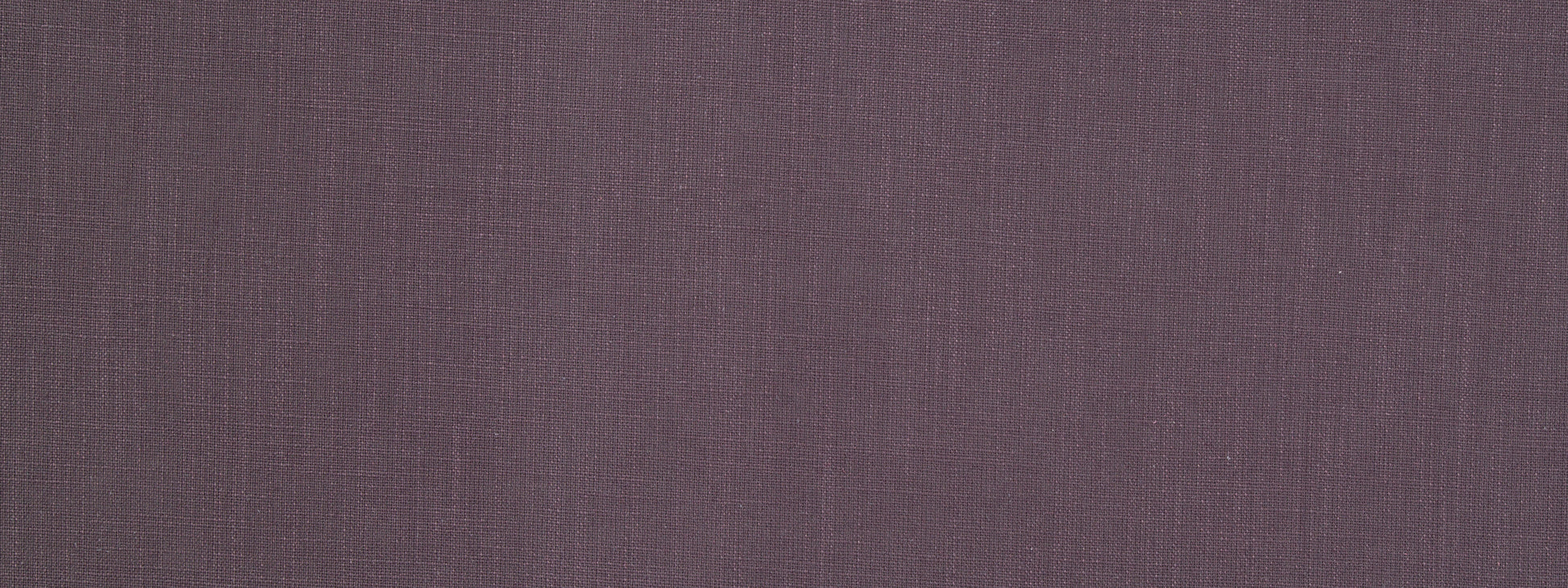 Close-up of muted plum-purple woven fabric texture with visible threads.