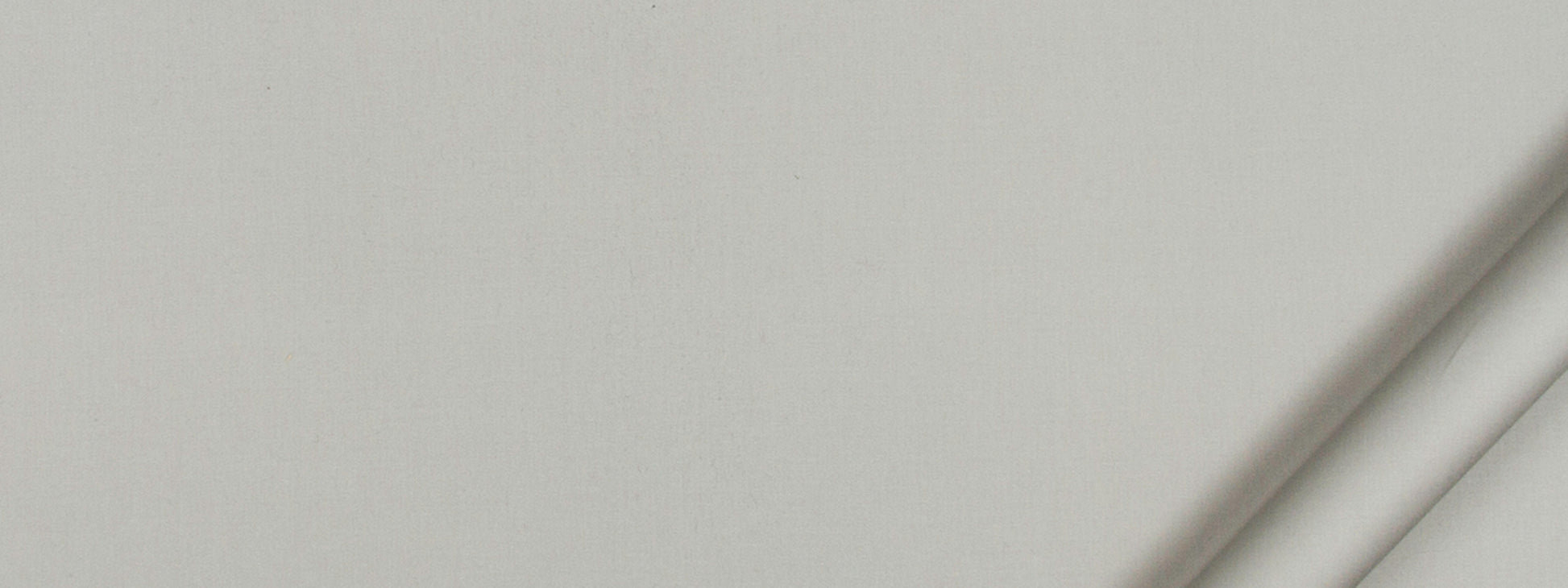 Soft gray fabric swatch with a subtle diagonal fold along the right edge.