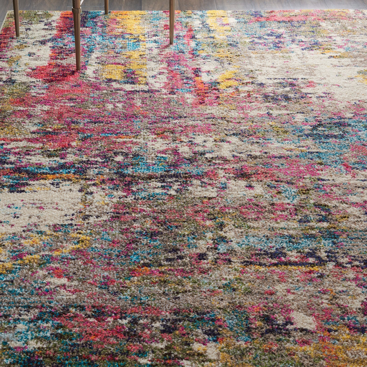 Abstract multicolor rug with pink, blue and yellow patches; plush pile; distressed look; modern living room decor.