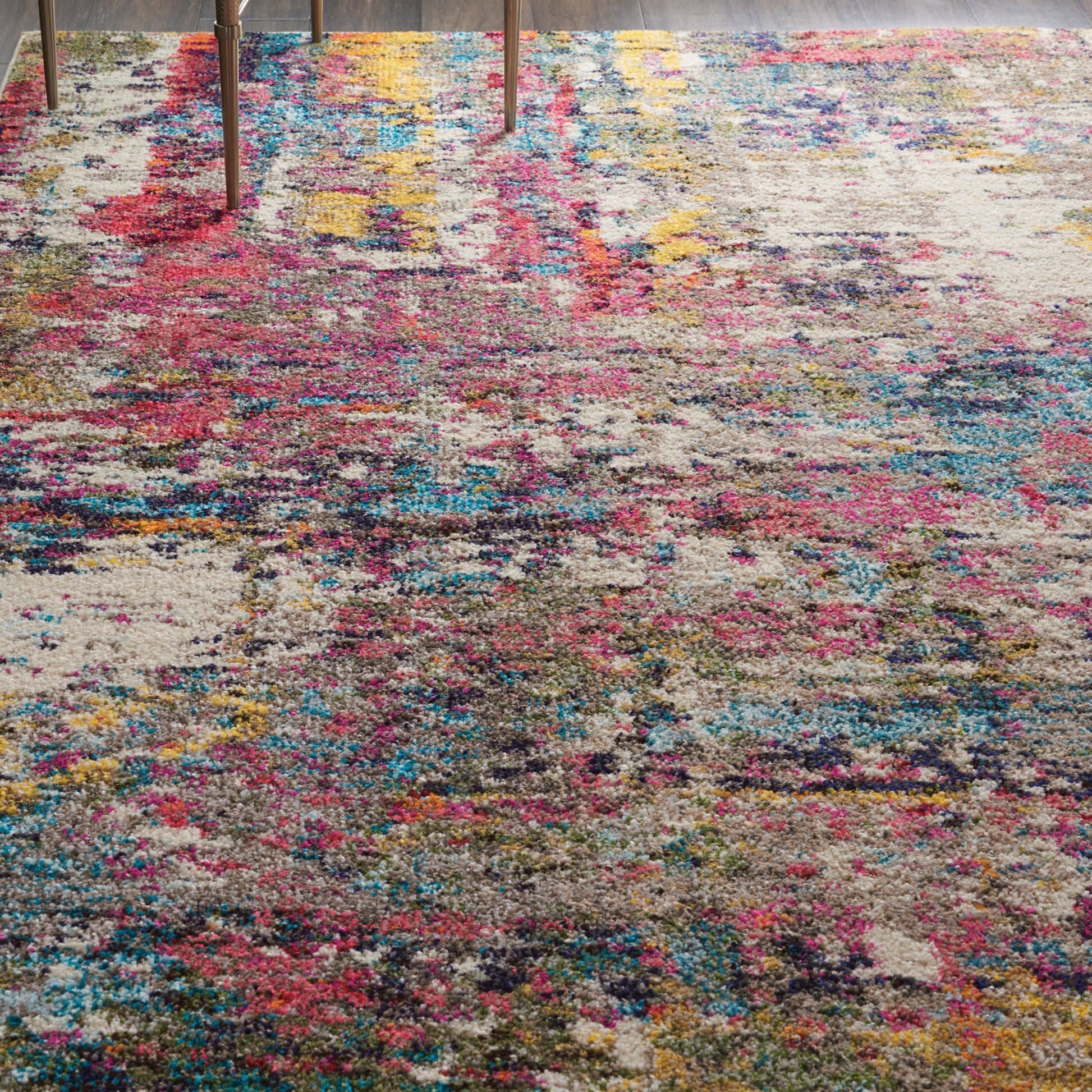 Abstract multicolor rug with pink, blue and yellow patches; plush pile; distressed look; modern living room decor.
