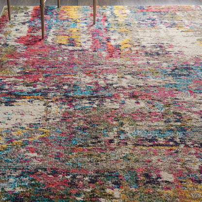 Abstract multicolor rug with pink, blue and yellow patches; plush pile; distressed look; modern living room decor.