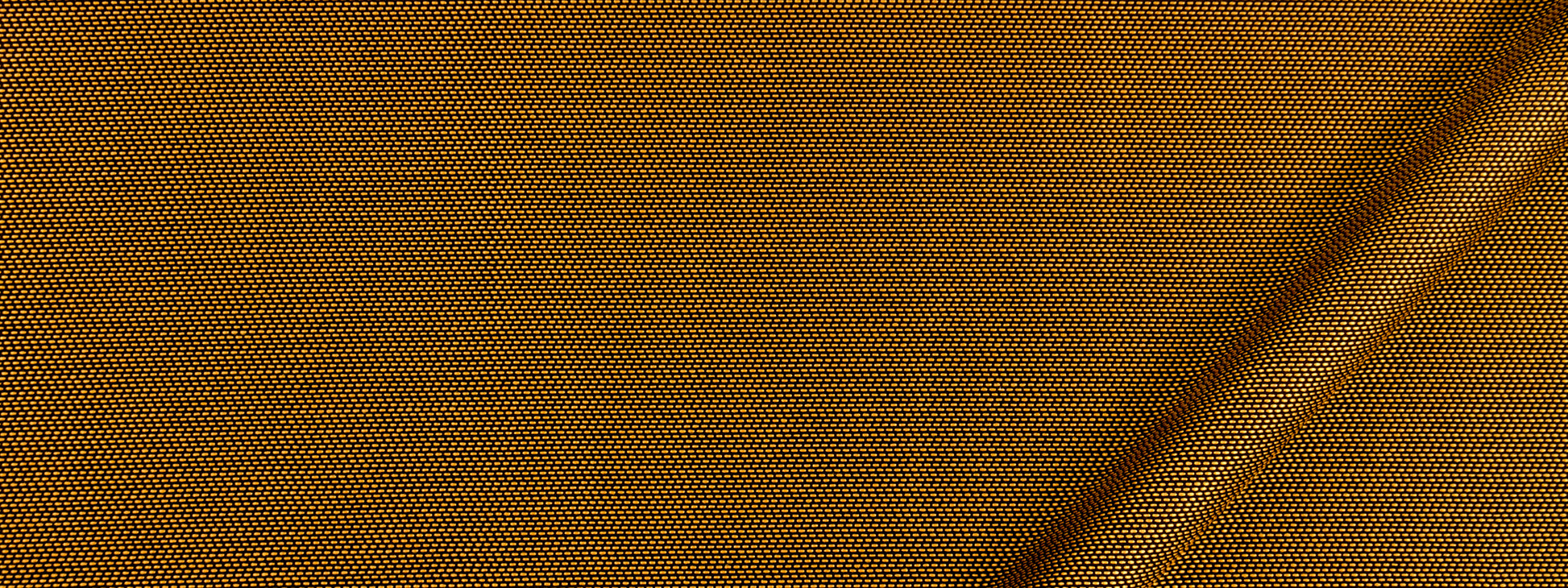 Close-up of gold upholstery fabric with a diagonal tan strap running across.