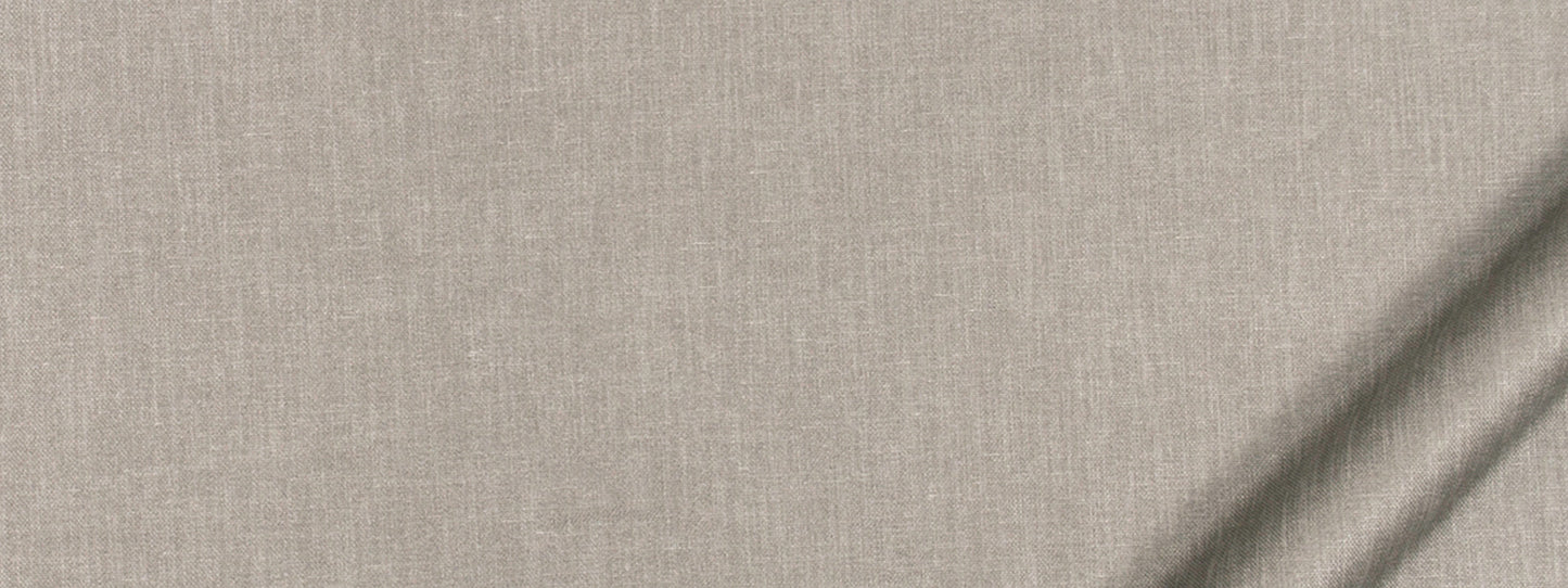 Beige linen fabric close-up with woven texture and diagonal light shadows.