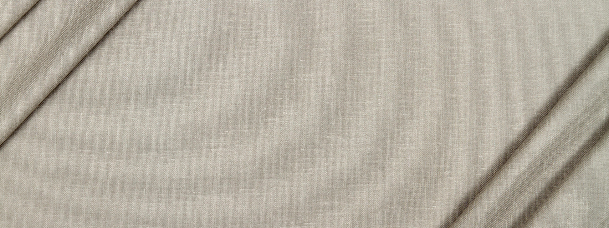 Beige linen fabric close-up with visible weave and soft folds.
