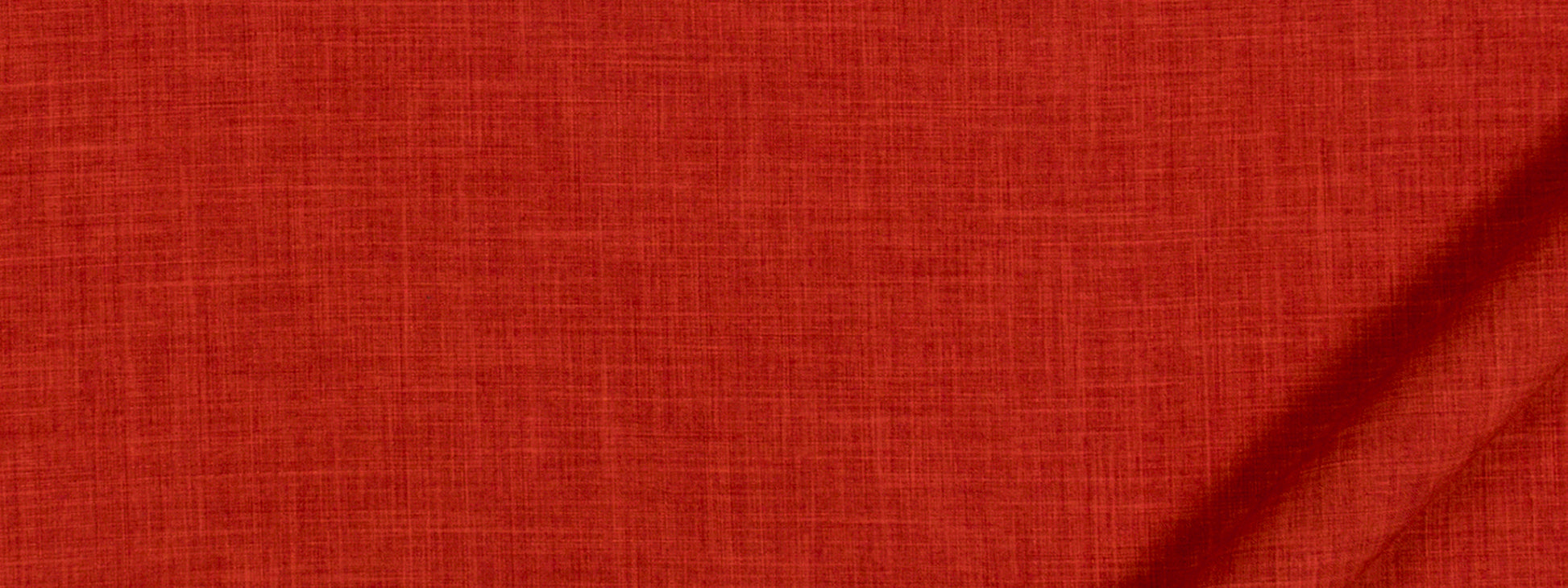 Close-up of red-orange woven fabric texture with visible fibers.
