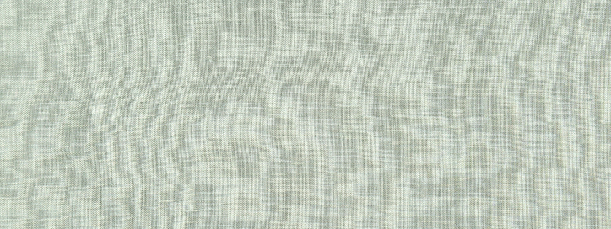 Light sage green linen fabric texture close-up with soft woven fibers.