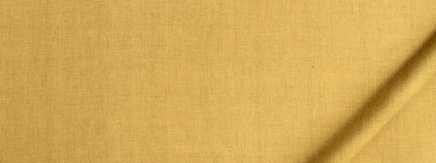 Golden yellow woven fabric close-up with visible texture and a diagonal crease.