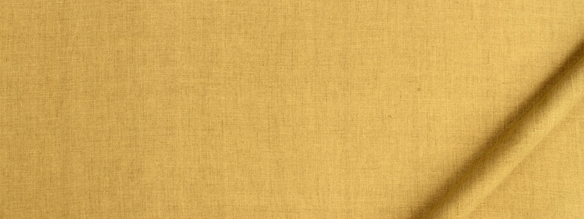 Golden yellow woven fabric close-up with visible texture and a diagonal crease.