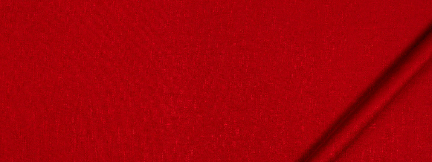 Close-up of bright red fabric with a dark diagonal seam along the edge; bold minimalist textile.
