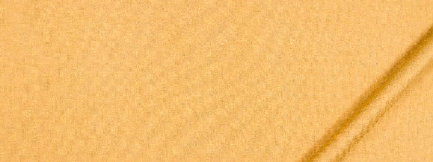 Yellow-orange fabric close-up with a diagonal seam, sunny textile suitable for garments or decor.