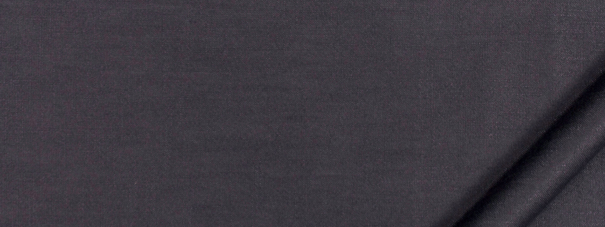 Charcoal grey fabric close-up showing soft weave and diagonal folds, versatile textile for apparel or upholstery