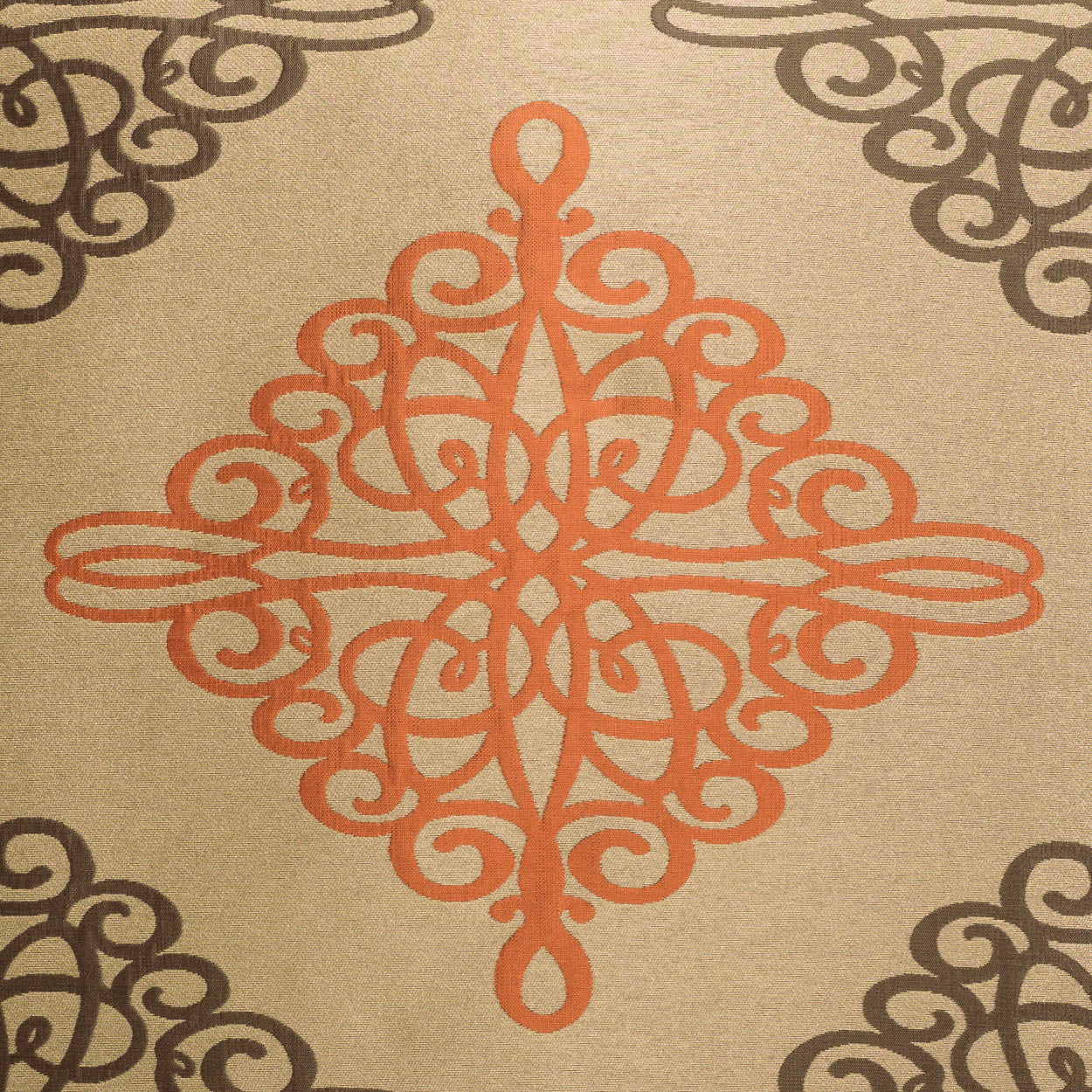 Beige fabric with orange ornamental center medallion and dark brown corner scroll patterns on a 24 x 24 inch pillow.