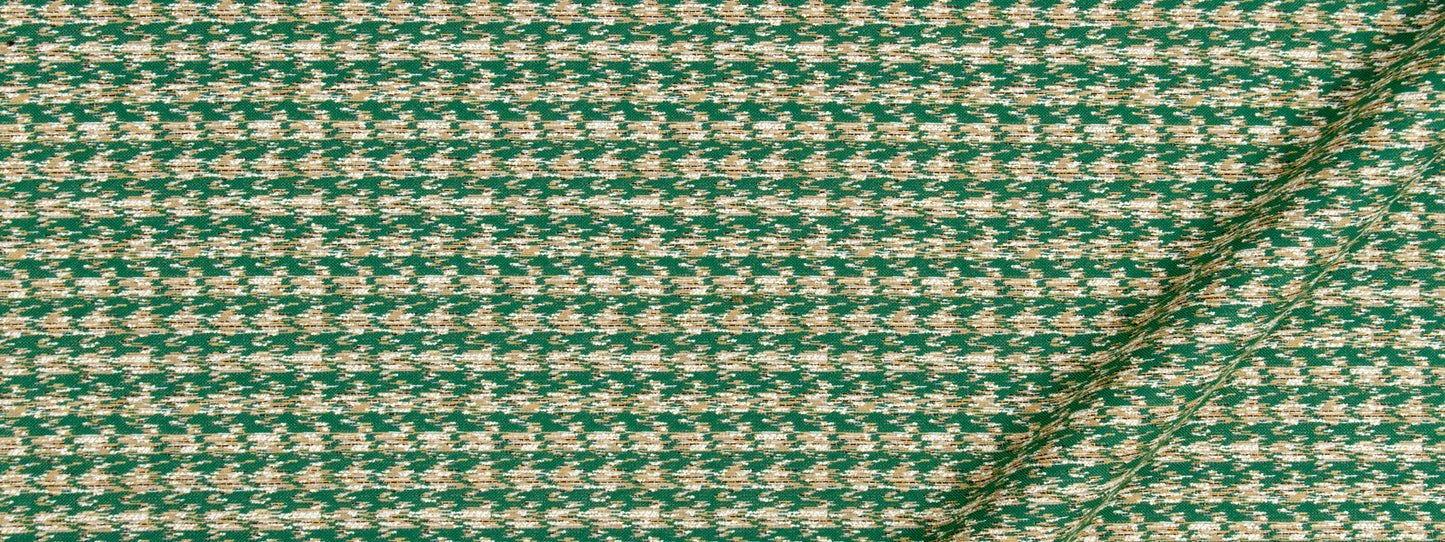 Green and cream houndstooth tweed fabric with wool texture and diagonal seam; ideal for jackets or upholstery.