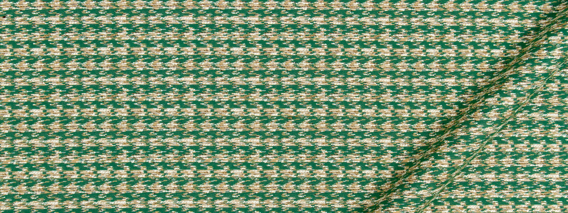 Green and cream houndstooth tweed fabric with wool texture and diagonal seam; ideal for jackets or upholstery.