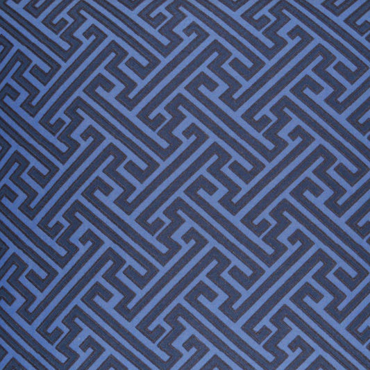 Dark blue square fabric panel over blue Greek-key patterned textile background.