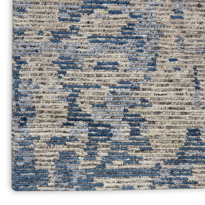 Blue and beige abstract-pattern woven rug with a textured look; modern, versatile for living rooms.