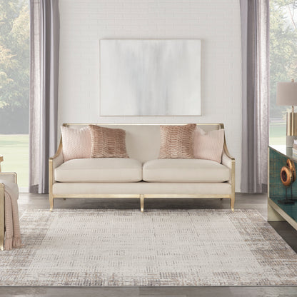 Cream rug in a bright glam living room with abstract art and neutral decor, 8' x 11'.