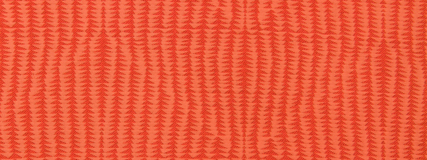 Coral upholstery fabric with a repeating chevron/zigzag rib pattern and woven texture.