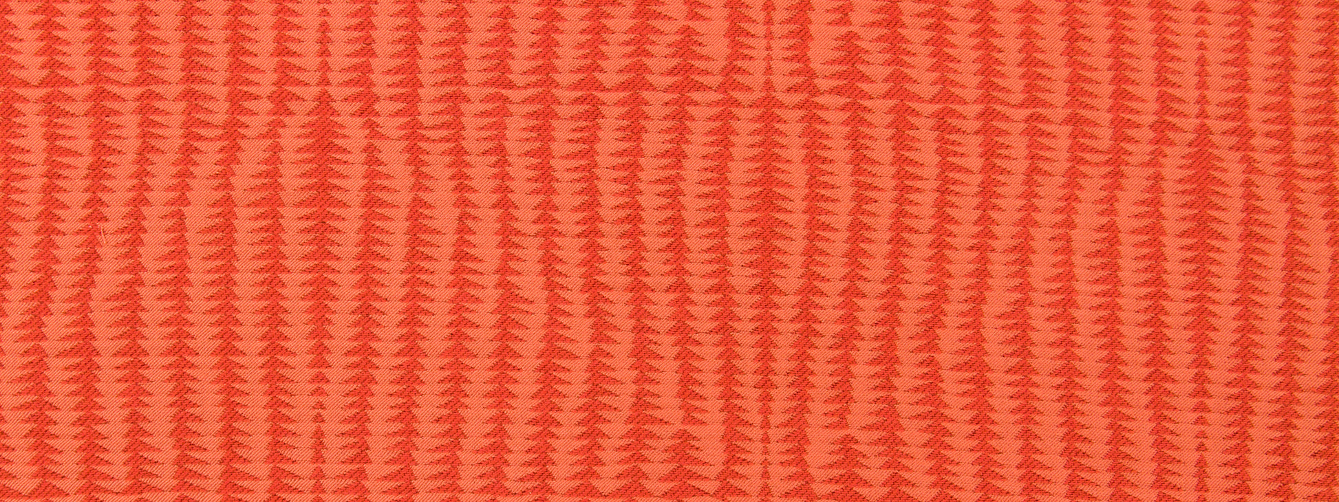 Coral upholstery fabric with a repeating chevron/zigzag rib pattern and woven texture.